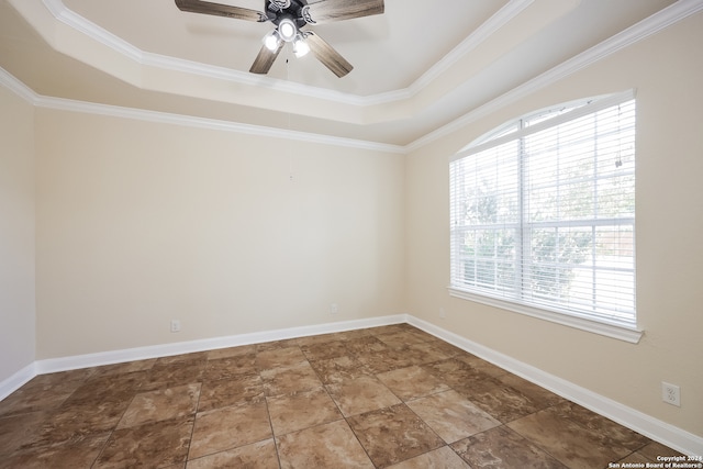 empty room featuring ceiling fan, a raised ceiling, and ornamental molding