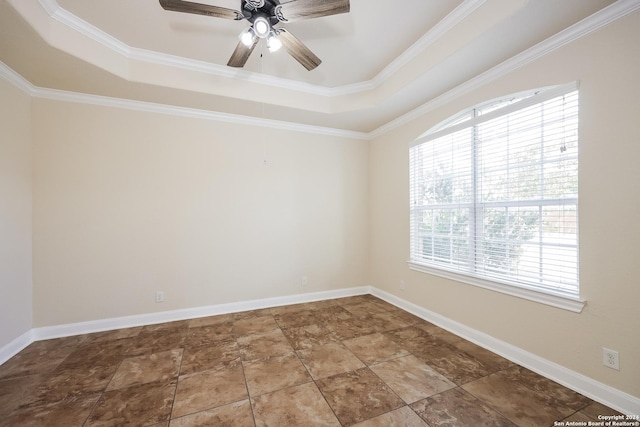 spare room featuring baseboards, a raised ceiling, ornamental molding, and a ceiling fan