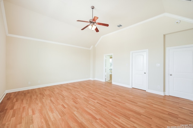 spare room featuring ornamental molding, vaulted ceiling, light hardwood / wood-style flooring, and ceiling fan