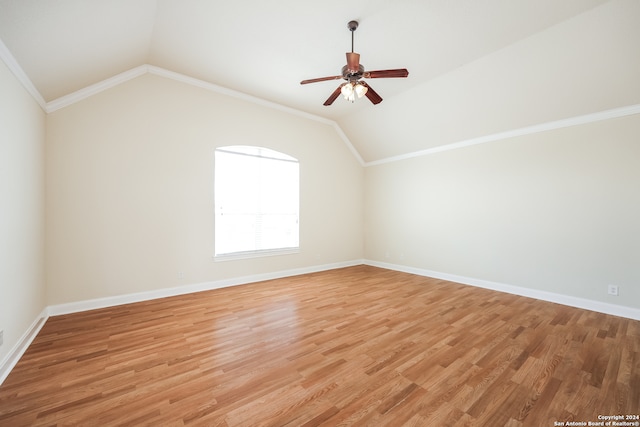 spare room with lofted ceiling, hardwood / wood-style floors, ceiling fan, and ornamental molding