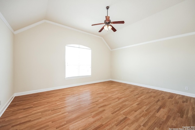 additional living space featuring baseboards, lofted ceiling, light wood-style floors, and a ceiling fan