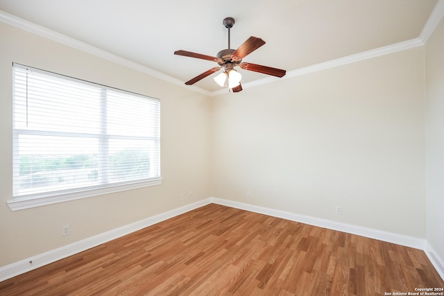 spare room featuring light wood-style flooring, a ceiling fan, baseboards, and ornamental molding