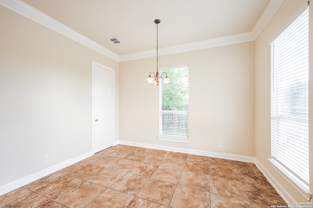 empty room with ornamental molding and an inviting chandelier