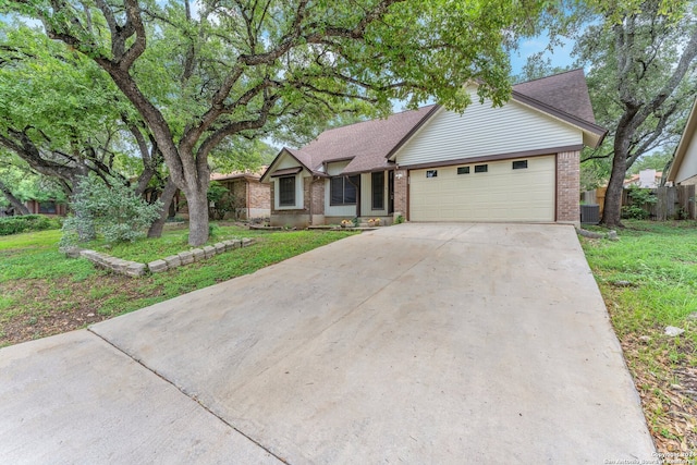 ranch-style home with central AC, a garage, and a front lawn