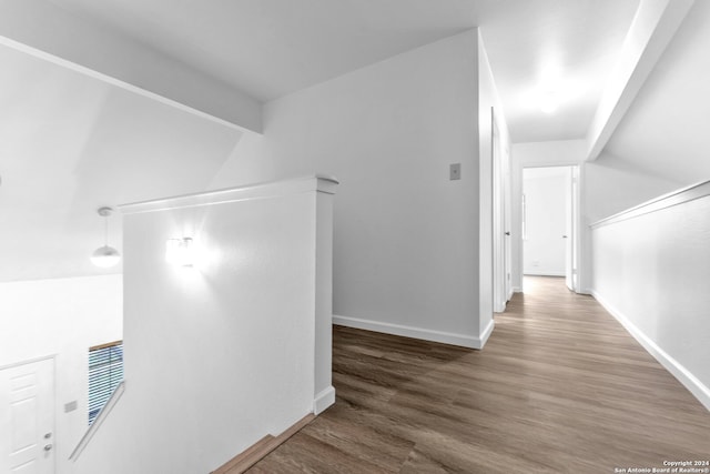 hall featuring hardwood / wood-style flooring and beamed ceiling