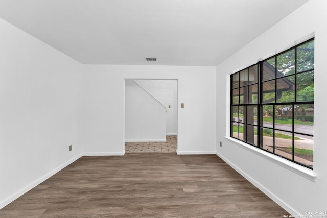 unfurnished room with dark hardwood / wood-style flooring