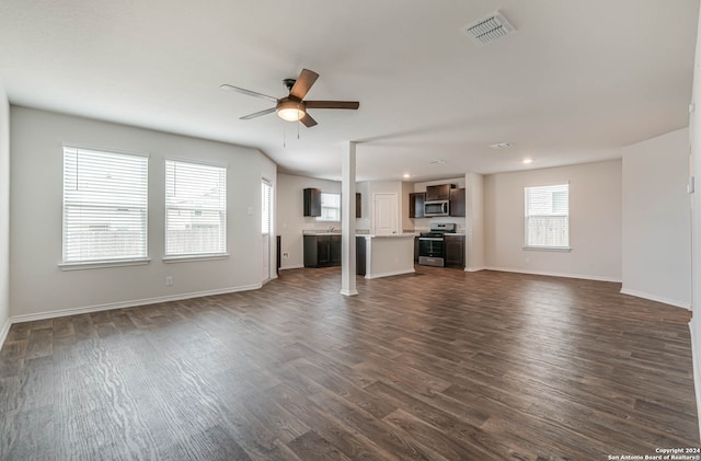 unfurnished living room featuring ceiling fan and dark hardwood / wood-style flooring