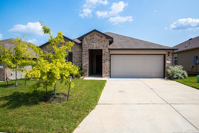 view of front of house featuring a garage and a front lawn