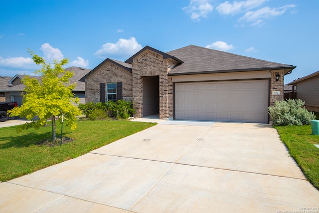 view of front of home with a front lawn and a garage