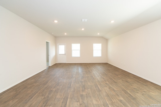 empty room featuring lofted ceiling and wood-type flooring