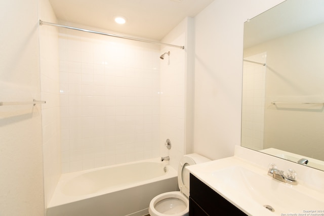 full bathroom featuring tiled shower / bath combo, vanity, and toilet