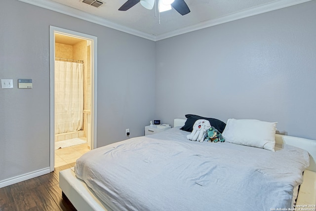 bedroom featuring dark hardwood / wood-style flooring, ceiling fan, connected bathroom, and ornamental molding