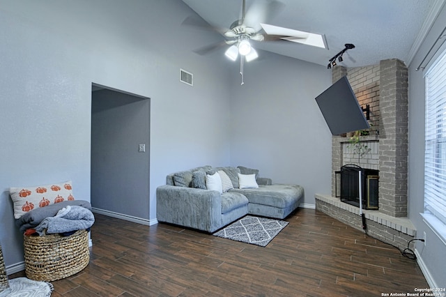 living room with dark wood-type flooring, a healthy amount of sunlight, ceiling fan, and lofted ceiling with skylight