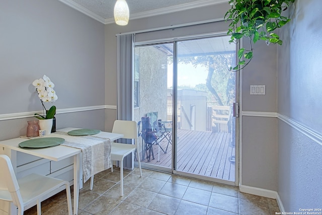 tiled dining area featuring ornamental molding