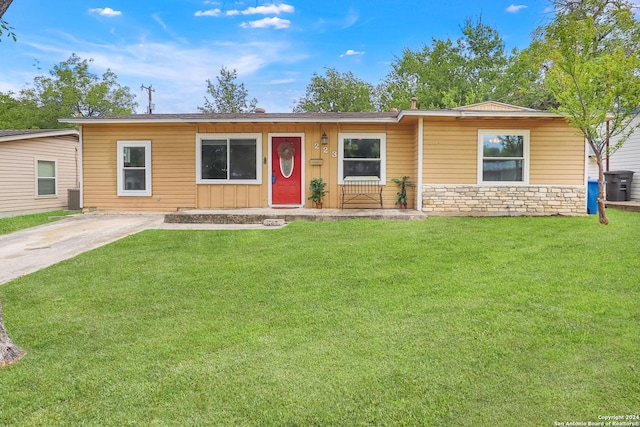 single story home featuring stone siding, a front yard, and central AC unit