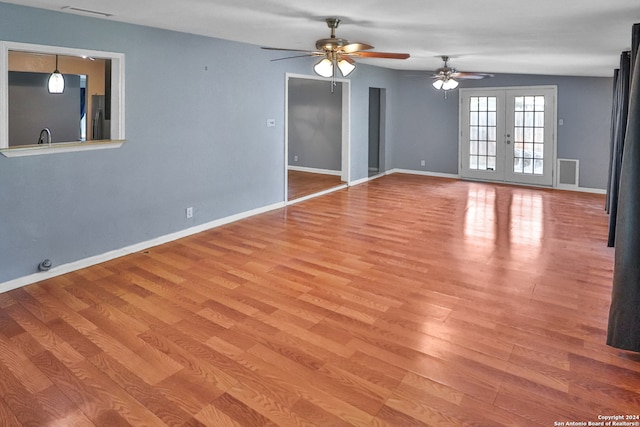 unfurnished room with french doors, ceiling fan, and light hardwood / wood-style flooring