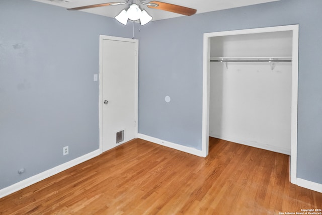 unfurnished bedroom featuring a closet, ceiling fan, and hardwood / wood-style flooring