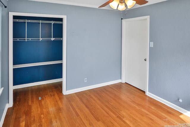 unfurnished bedroom with a closet, wood-type flooring, and ceiling fan