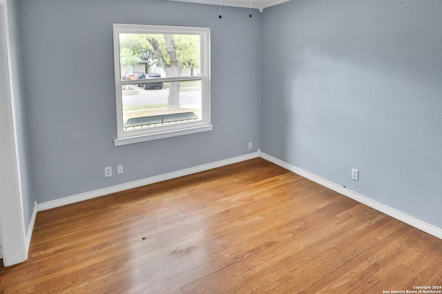 spare room with hardwood / wood-style floors