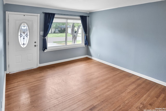 entryway with crown molding and hardwood / wood-style floors