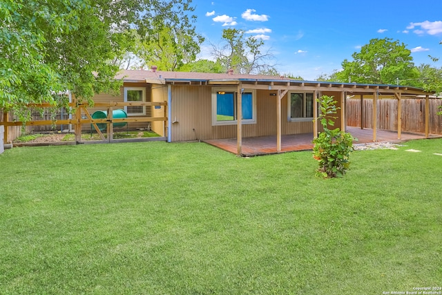 rear view of house with a lawn and a patio