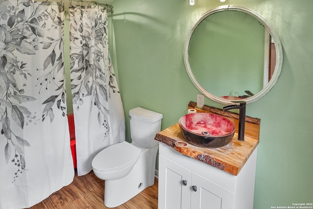 bathroom with vanity, toilet, a shower with curtain, and hardwood / wood-style floors