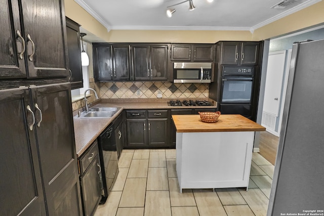 kitchen with light wood-type flooring, crown molding, butcher block countertops, black appliances, and sink