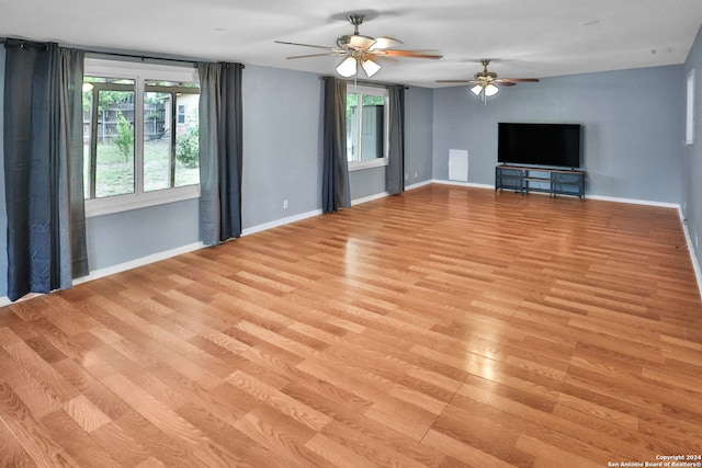 unfurnished living room with light hardwood / wood-style flooring and ceiling fan