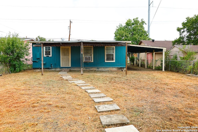 view of front facade featuring cooling unit and a carport