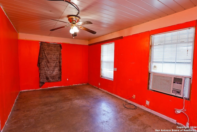 unfurnished room featuring concrete floors, ceiling fan, and cooling unit