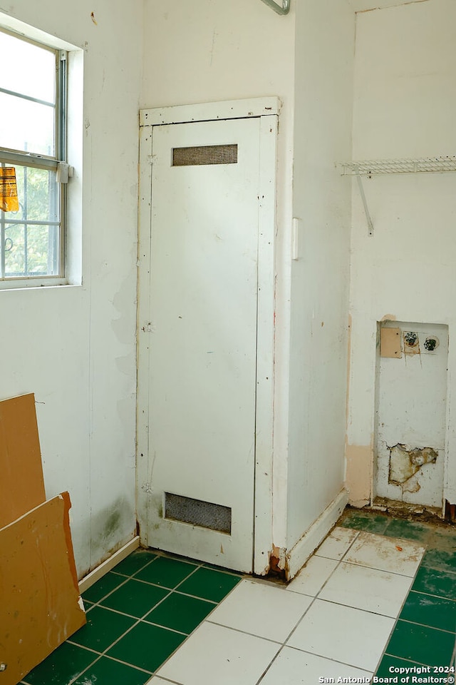 doorway to outside with tile patterned flooring