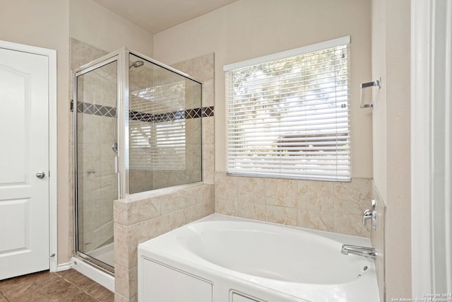 bathroom featuring plenty of natural light, independent shower and bath, and tile patterned floors