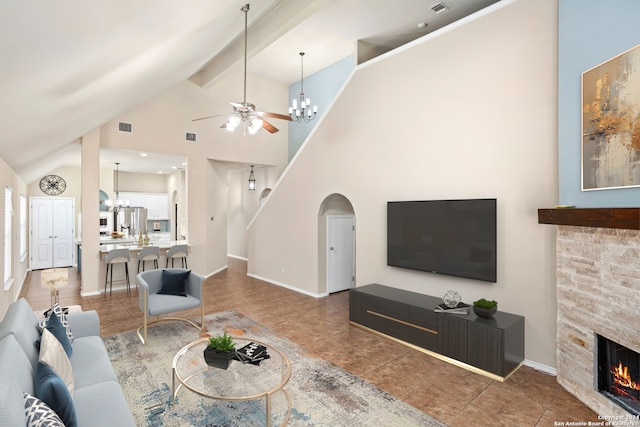 tiled living room featuring beamed ceiling, ceiling fan with notable chandelier, high vaulted ceiling, and a fireplace