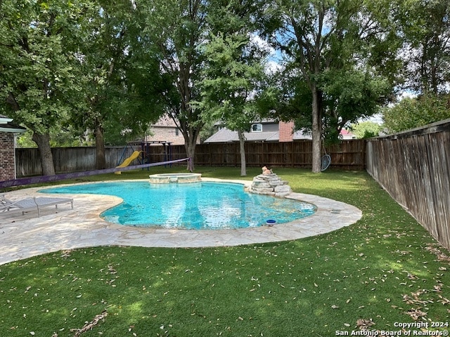 view of swimming pool with a patio area and a yard