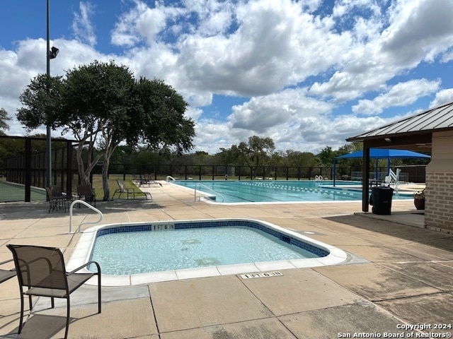 view of swimming pool with a patio area