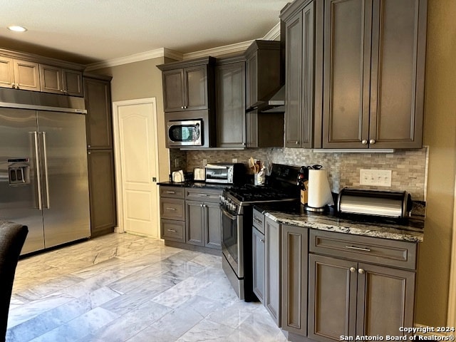 kitchen with dark stone countertops, ornamental molding, stainless steel appliances, and tasteful backsplash