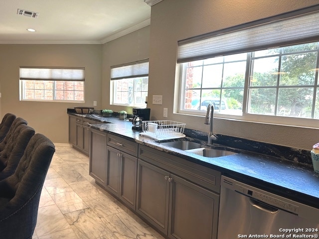 kitchen featuring dishwasher, dark stone counters, ornamental molding, and sink