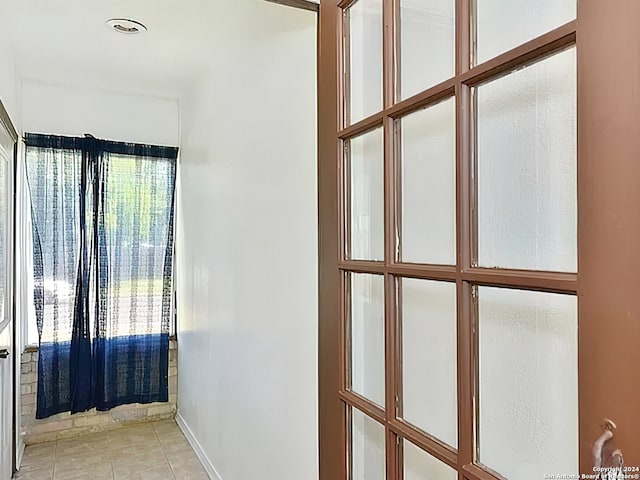 hall with light tile patterned flooring