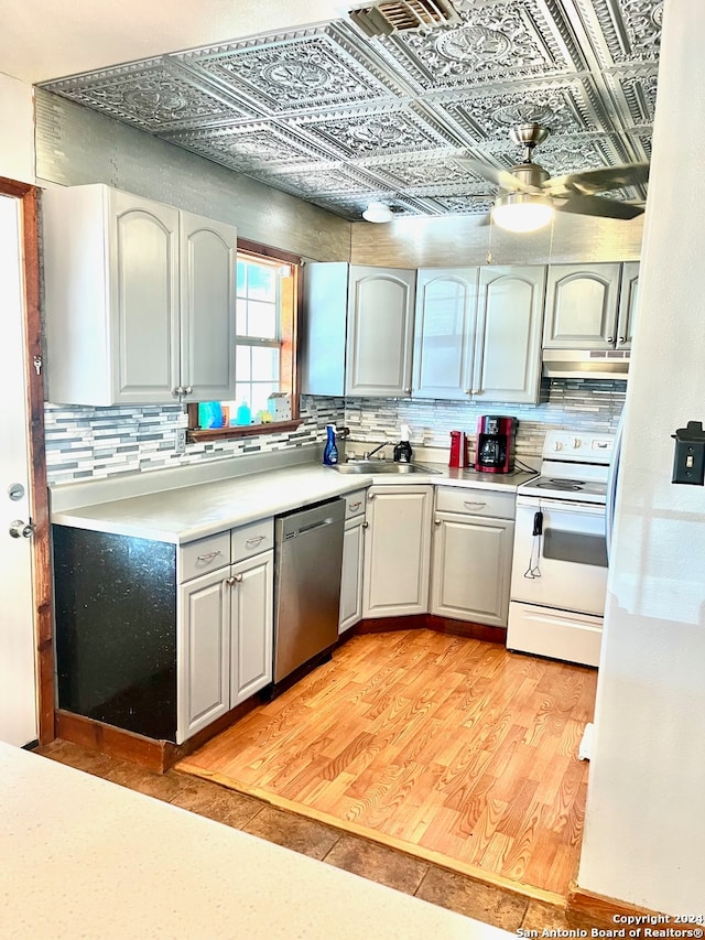 kitchen with white electric range, light hardwood / wood-style flooring, decorative backsplash, and stainless steel dishwasher