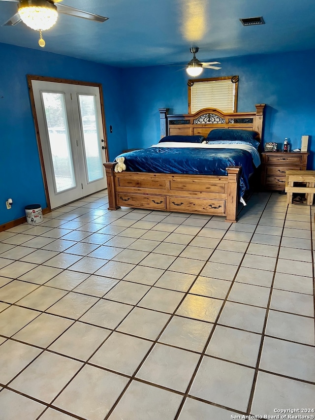 tiled bedroom featuring ceiling fan