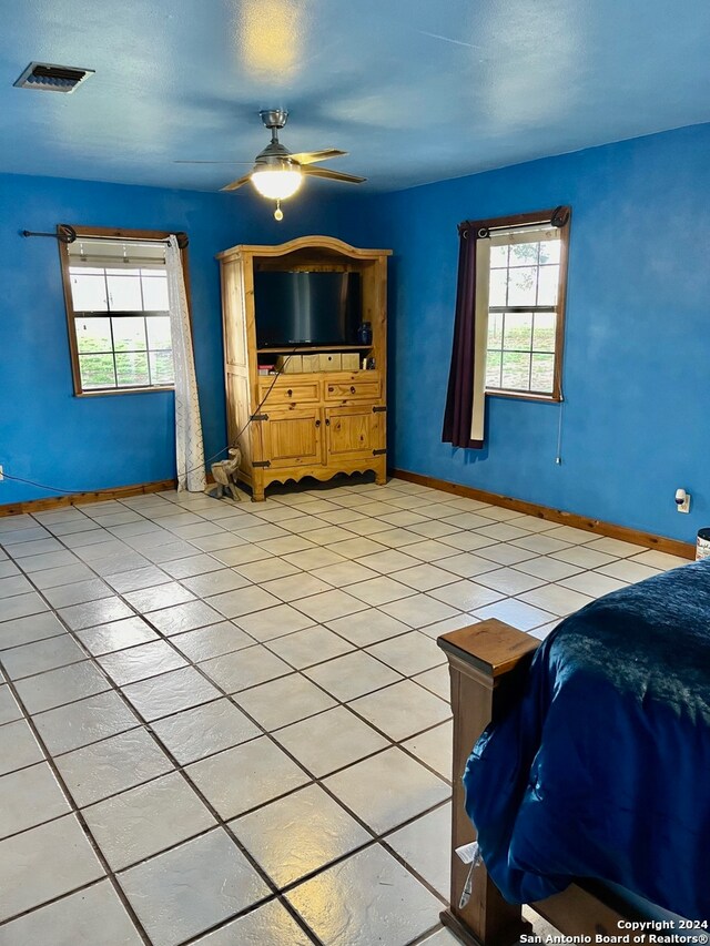 tiled living room featuring ceiling fan