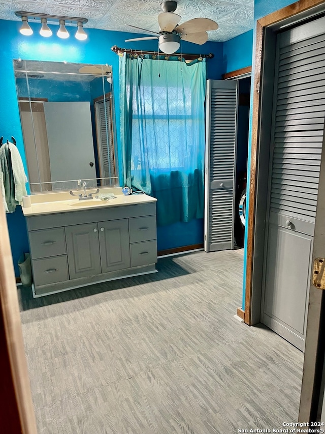 bathroom with ceiling fan, hardwood / wood-style flooring, a textured ceiling, and vanity