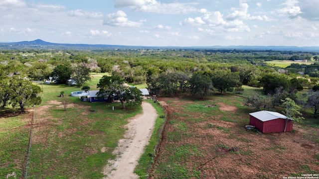 birds eye view of property featuring a mountain view and a rural view