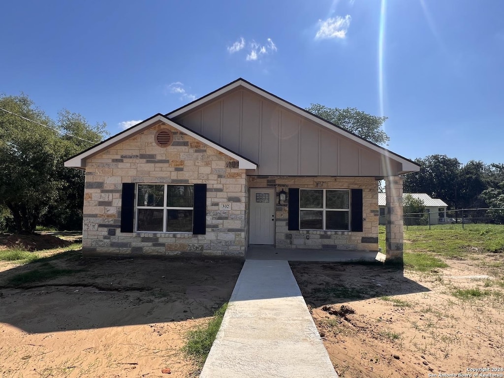 view of front of house featuring fence and board and batten siding