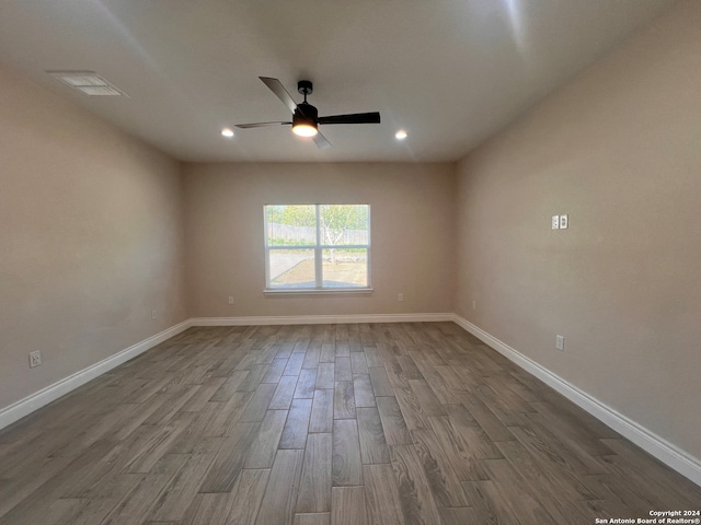 spare room with hardwood / wood-style floors and ceiling fan