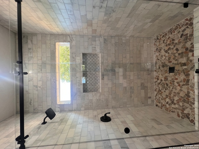 bathroom with a wealth of natural light and tile patterned floors