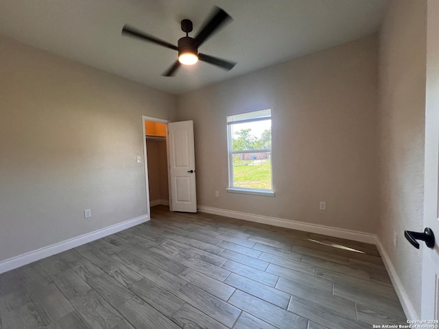 spare room featuring light hardwood / wood-style flooring and ceiling fan