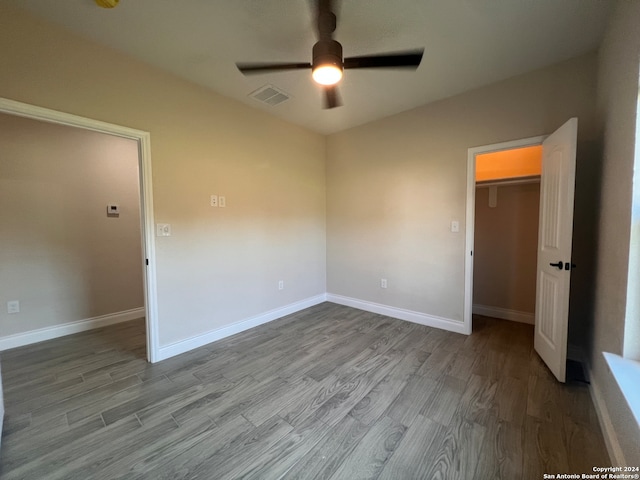 unfurnished bedroom featuring ceiling fan and hardwood / wood-style flooring