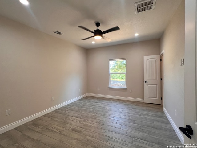 empty room with hardwood / wood-style flooring and ceiling fan