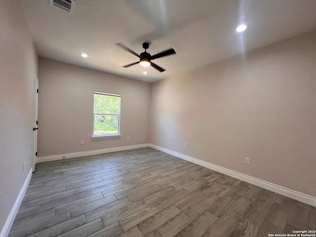 empty room with hardwood / wood-style flooring and ceiling fan